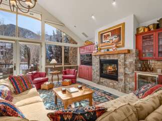 This stunning living room boasts a cozy fireplace, perfect for chilly evenings.