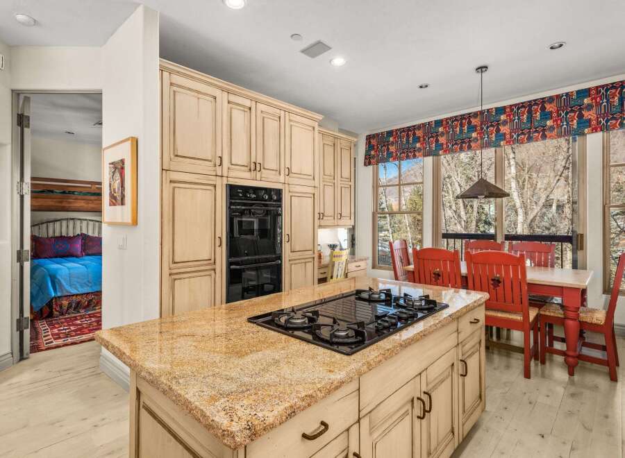 This stunning kitchen boasts a spacious island with a gas cooktop, perfect for culinary enthusiasts.