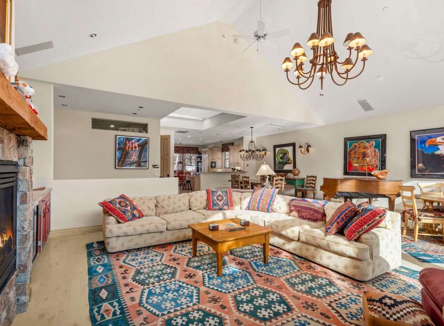 Step into luxury with this stunning living space, featuring a cozy fireplace and a stylish sectional sofa.