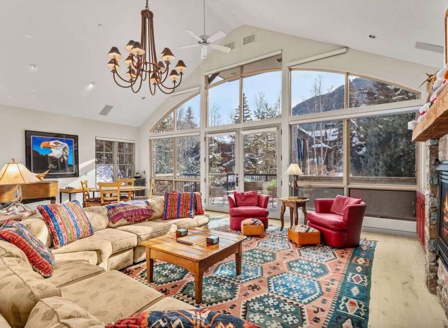 Experience luxury living in this stunning property, featuring a spacious living room with breathtaking mountain views.