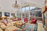 Experience luxury living in this stunning property, featuring a spacious living room with breathtaking mountain views.