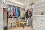 Step into luxury with this meticulously organized walk-in closet, offering ample space for your wardrobe.
