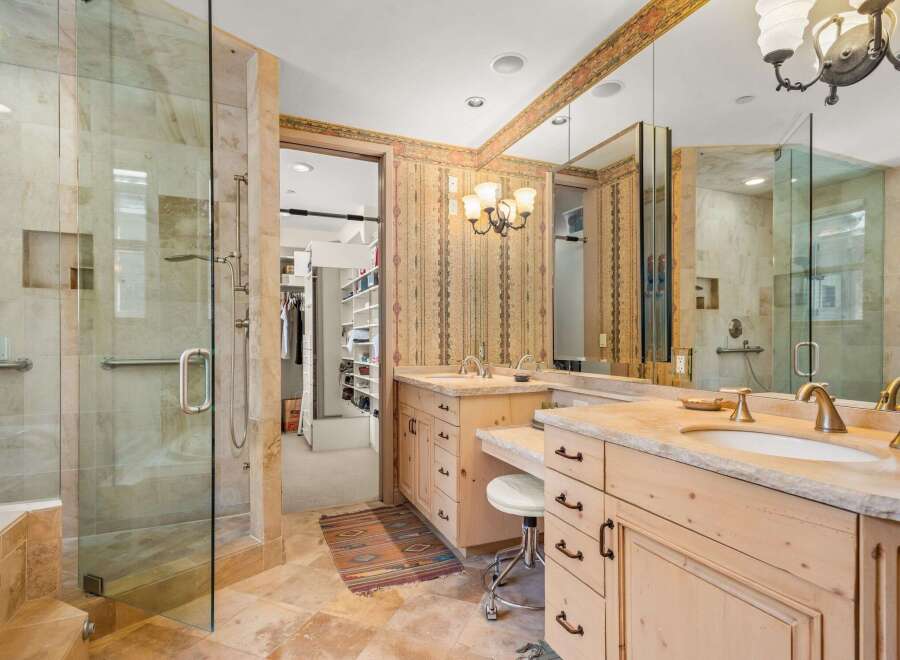 Step into luxury with this stunning bathroom featuring a spacious walk-in shower and elegant vanity.