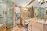 Step into luxury with this stunning bathroom featuring a spacious walk-in shower and elegant vanity.