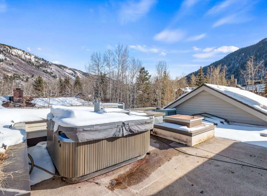 Enjoy breathtaking mountain views from this luxurious property featuring a private hot tub, perfect for relaxing after a day on the slopes.