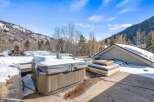 Enjoy breathtaking mountain views from this luxurious property featuring a private hot tub, perfect for relaxing after a day on the slopes.
