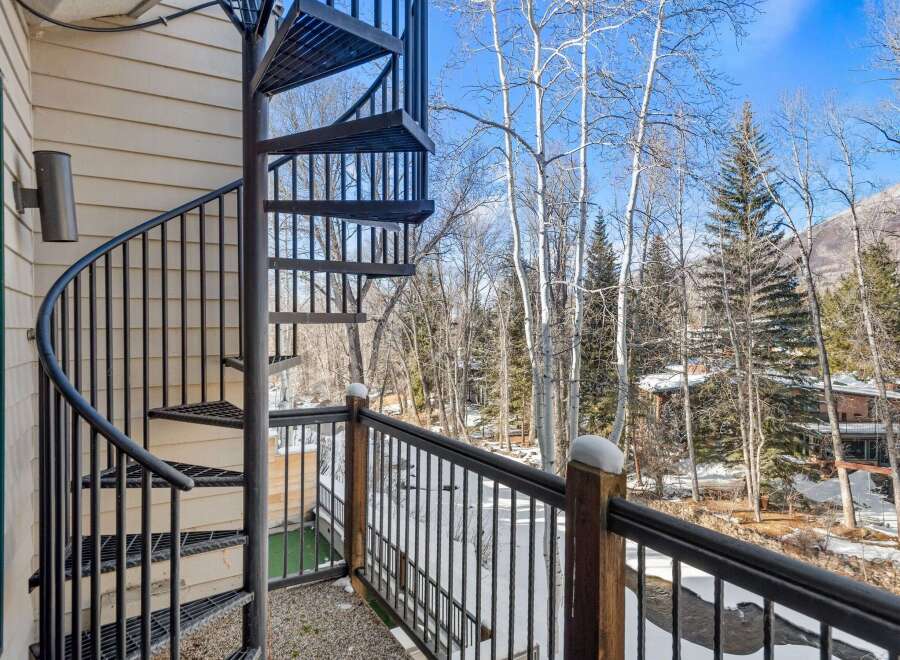 Enjoy stunning views from this property featuring a unique spiral staircase and a private balcony.