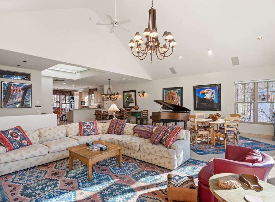 This stunning property boasts a spacious living area with a grand piano, perfect for entertaining.