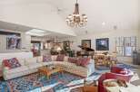 This stunning property boasts a spacious living area with a grand piano, perfect for entertaining.