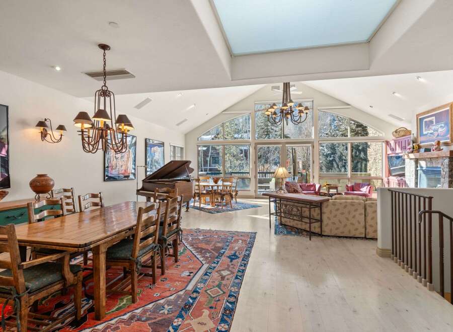 Experience luxury living in this stunning property, featuring a grand piano and a spacious dining area perfect for entertaining.