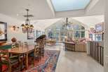 Experience luxury living in this stunning property, featuring a grand piano and a spacious dining area perfect for entertaining.