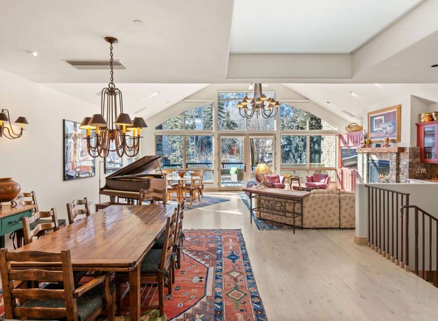 Experience luxury living in this stunning property, featuring a grand piano and a spacious dining area perfect for entertaining.