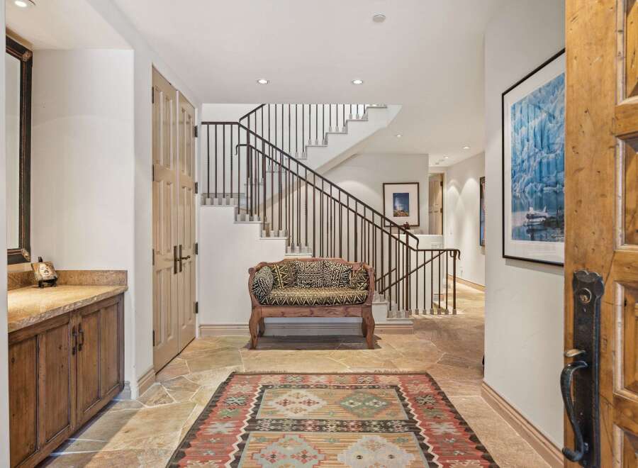 Step into luxury with this stunning entryway, showcasing a grand staircase and exquisite design.