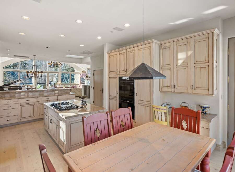 This stunning kitchen boasts a spacious layout with custom cabinetry and a gourmet island.