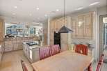 This stunning kitchen boasts a spacious layout with custom cabinetry and a gourmet island.