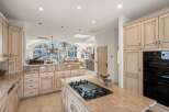 Step into luxury with this stunning kitchen, boasting exquisite cabinetry and a spacious layout perfect for culinary enthusiasts.