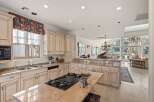 This stunning kitchen boasts a gourmet gas cooktop, perfect for culinary enthusiasts.