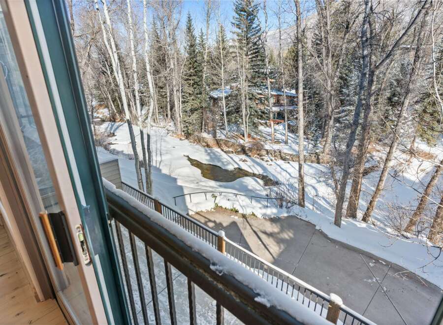 Enjoy breathtaking views from this stunning property! This home offers a serene setting with a beautiful stream and lush trees.