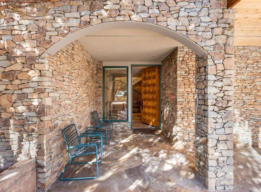This stunning property boasts a beautiful stone facade, creating a warm and inviting curb appeal.
