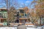 This stunning property boasts a unique architectural design with a stone facade and large windows, creating a modern and inviting atmosphere.