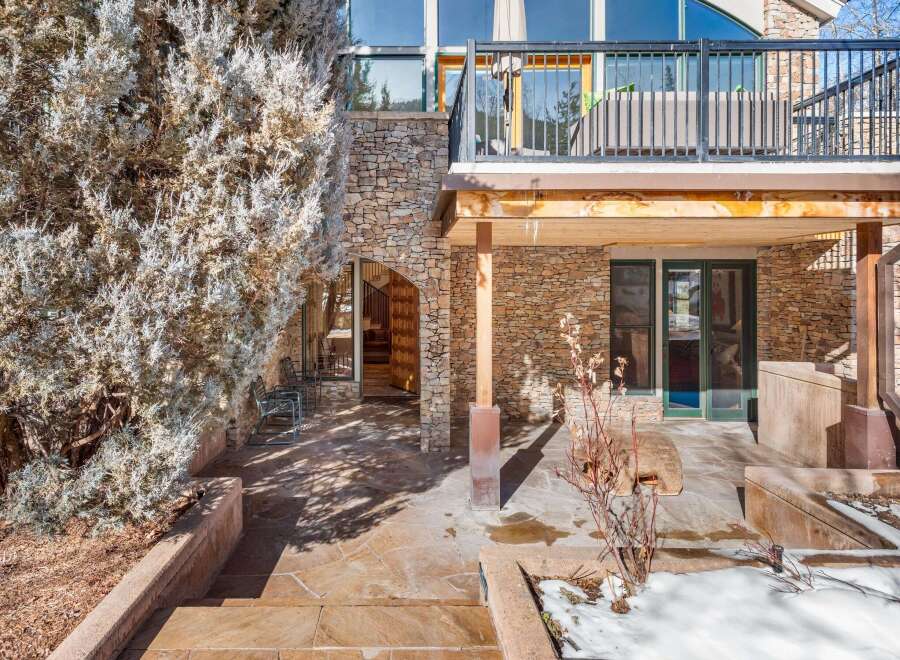 This stunning property boasts a beautiful stone exterior and a spacious outdoor patio, perfect for entertaining or relaxing.