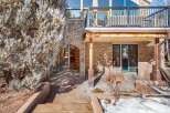 This stunning property boasts a beautiful stone exterior and a spacious outdoor patio, perfect for entertaining or relaxing.