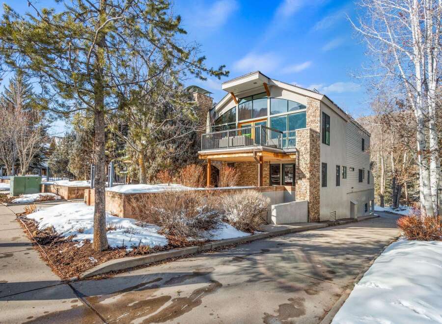 This stunning property boasts a modern architectural design with a blend of stone and sleek lines.