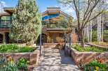 Experience luxury mountain living in this stunning property featuring a modern architectural design with expansive windows and a spacious balcony perfect for enjoying the serene surroundings.