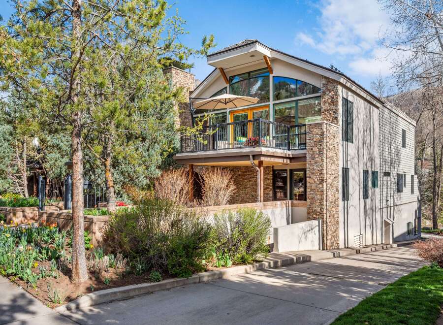 Experience luxury mountain living in this stunning home featuring a striking stone facade and expansive windows that capture breathtaking views.
