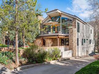 Experience luxury mountain living in this stunning home featuring a striking stone facade and expansive windows that capture breathtaking views.