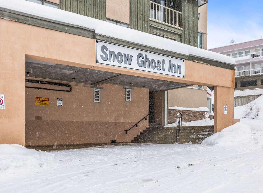 The Snow Ghost Inn, nestled in a snowy landscape, offers a cozy retreat.