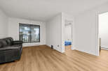 This stunning property boasts a modern living space with sleek hardwood floors and bright, white walls.