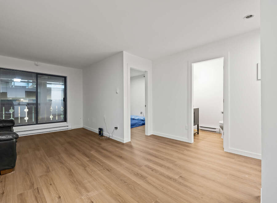 This bright and airy living space offers a modern aesthetic with its sleek design and ample natural light.