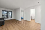 This bright and airy living space offers a modern aesthetic with its sleek design and ample natural light.