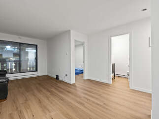 This bright and airy living space offers a modern aesthetic with its sleek design and ample natural light.