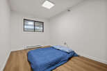 This cozy bedroom features a comfortable bed with a blue comforter and pillows, perfect for a relaxing night's sleep.