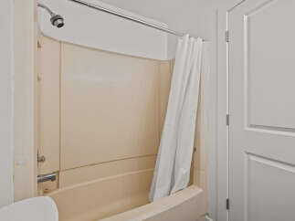 Step into this inviting bathroom, featuring a clean and well-maintained shower area.