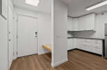 Step into this modern apartment featuring a bright entryway and a sleek kitchen.