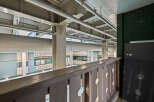 This image showcases a unique architectural design with exposed beams and pipes, creating an industrial aesthetic.