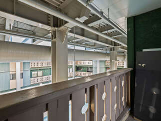 This image showcases a unique architectural design with exposed beams and pipes, creating an industrial aesthetic.