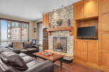 This stunning living room features a cozy fireplace with a stone surround, perfect for those chilly evenings.