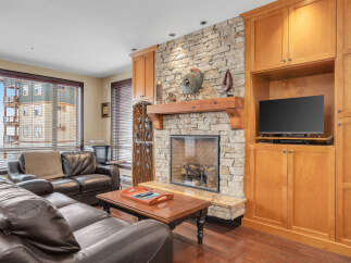 This stunning living room features a cozy fireplace with a stone surround, perfect for those chilly evenings.