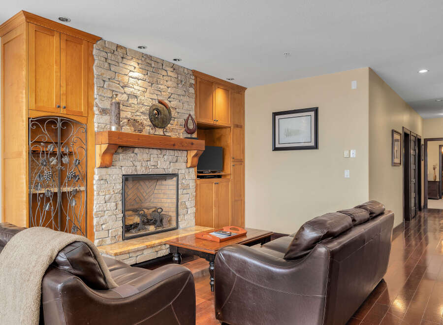 This stunning living room boasts a beautiful stone fireplace, perfect for cozy evenings.