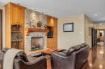 This stunning living room boasts a beautiful stone fireplace, perfect for cozy evenings.