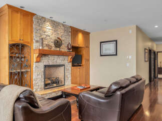 This stunning living room boasts a beautiful stone fireplace, perfect for cozy evenings.