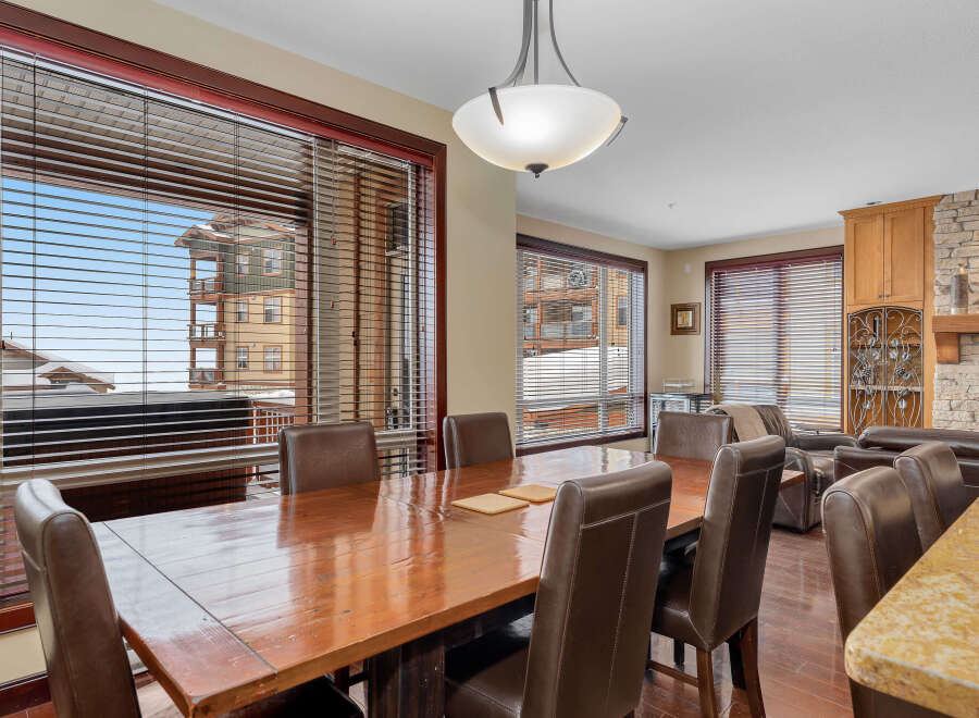 This stunning dining room boasts a warm and inviting atmosphere, perfect for hosting gatherings.