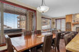 This stunning dining room boasts a warm and inviting atmosphere, perfect for hosting gatherings.