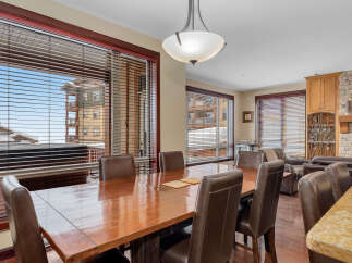 This stunning dining room boasts a warm and inviting atmosphere, perfect for hosting gatherings.