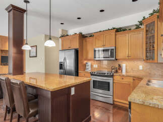 This stunning kitchen boasts a warm and inviting atmosphere, perfect for both everyday living and entertaining.