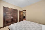 Step into a beautifully designed bedroom featuring rich, dark wood doors that add a touch of elegance.
